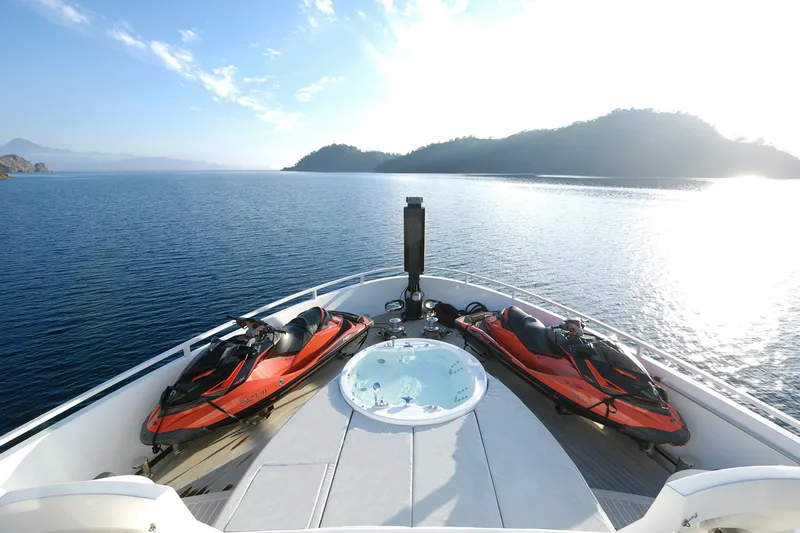 Sun Yacht Photos Pics Luxurious 2012 Arcadia Yachts 115 with jet skis and jacuzzi on deck, scenic ocean view.