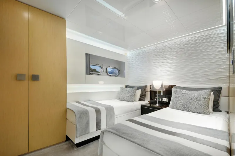 Sun Yacht Photos Pics Luxurious twin bedroom on 2012 Arcadia Yachts 115, featuring modern decor and elegant lighting.
