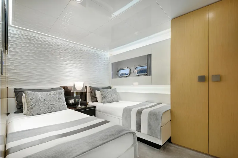 Sun Yacht Photos Pics Luxurious twin bedroom on 2012 Arcadia Yachts 115, featuring modern decor and elegant design.