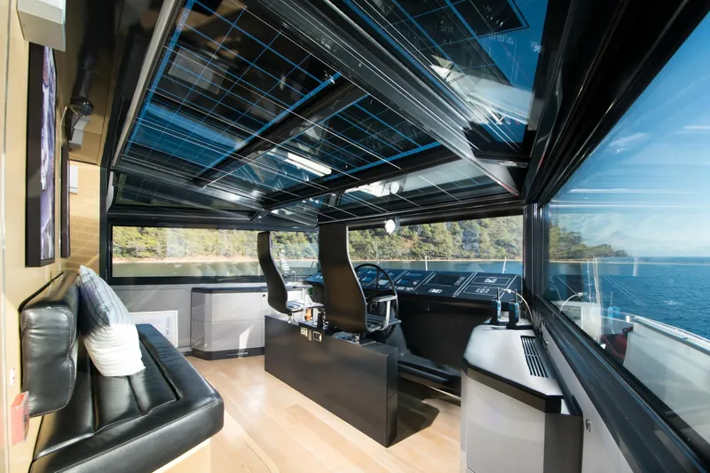 Sun Yacht Photos Pics Luxurious interior of 2012 Arcadia Yachts 115 with panoramic windows and modern helm.