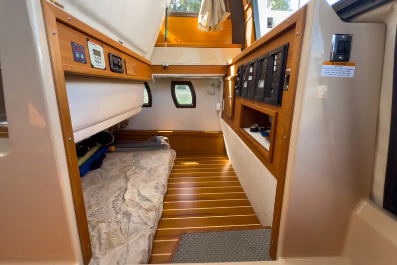  Yacht Photos Pics 2018 Ranger Tugs R-29 S interior cabin with wood flooring and cozy sleeping area.