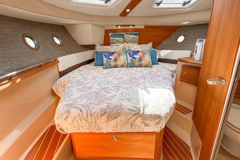  Yacht Photos Pics Luxurious 2018 Ranger Tugs R-29 S cabin interior with cozy bed and elegant wood finish.