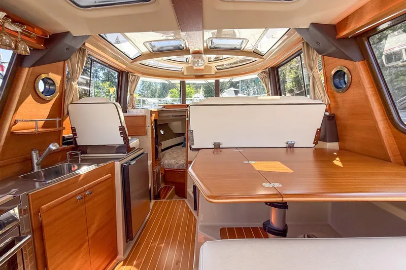  Yacht Photos Pics Interior of 2018 Ranger Tugs R-29 S with wood finish and spacious seating area.