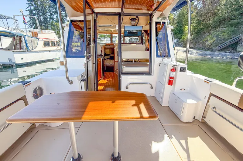  Yacht Photos Pics 2018 Ranger Tugs R-29 S boat interior with wooden table and open cabin view.