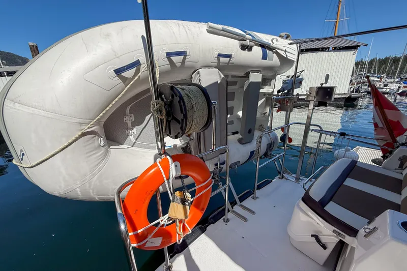  Yacht Photos Pics 2018 Ranger Tugs R-29 S with lifebuoy and dinghy at marina.