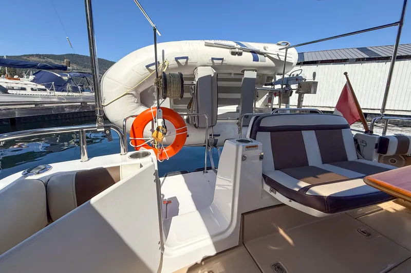  Yacht Photos Pics 2018 Ranger Tugs R-29 S boat deck with seating, life preserver, and inflatable dinghy.