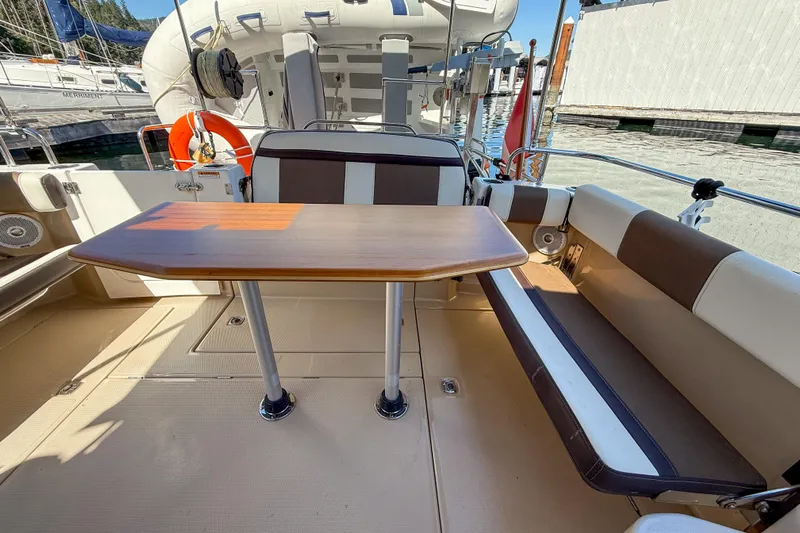  Yacht Photos Pics 2018 Ranger Tugs R-29 S boat deck with seating and table, docked at marina.