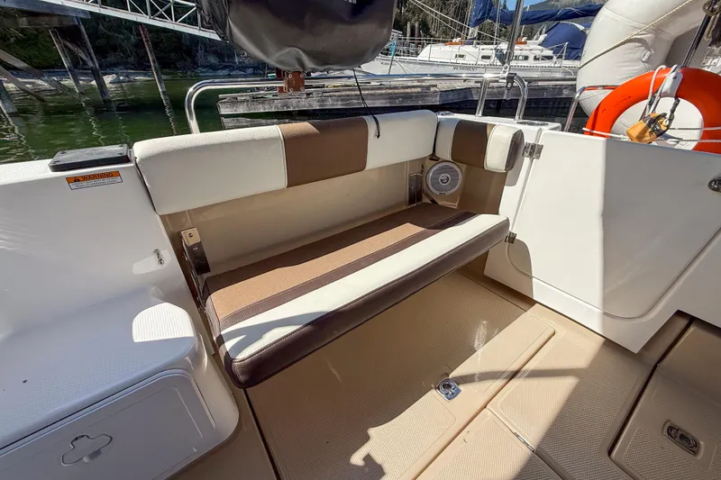  Yacht Photos Pics 2018 Ranger Tugs R-29 S boat seating area with cushioned bench and storage.