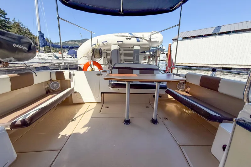  Yacht Photos Pics 2018 Ranger Tugs R-29 S boat deck with seating, table, and canopy.