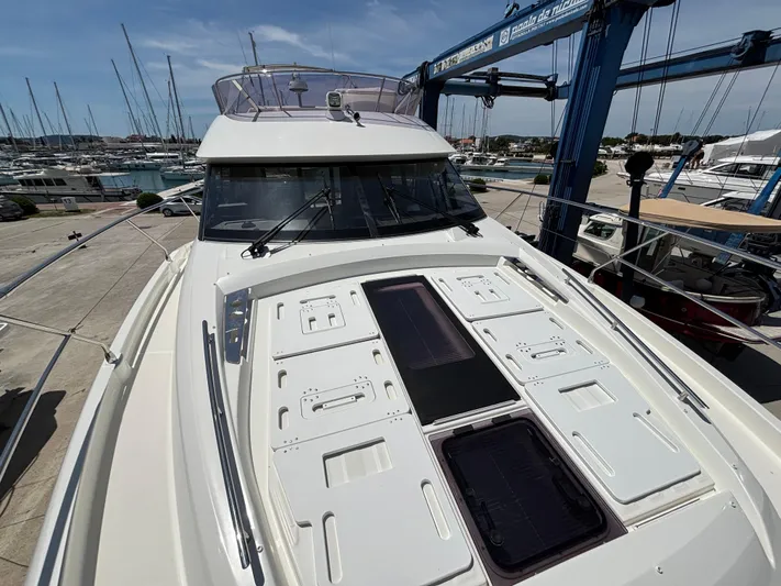  Yacht Photos Pics 2020 Jeanneau Prestige 460 yacht on dry dock, showcasing sleek design and spacious deck.