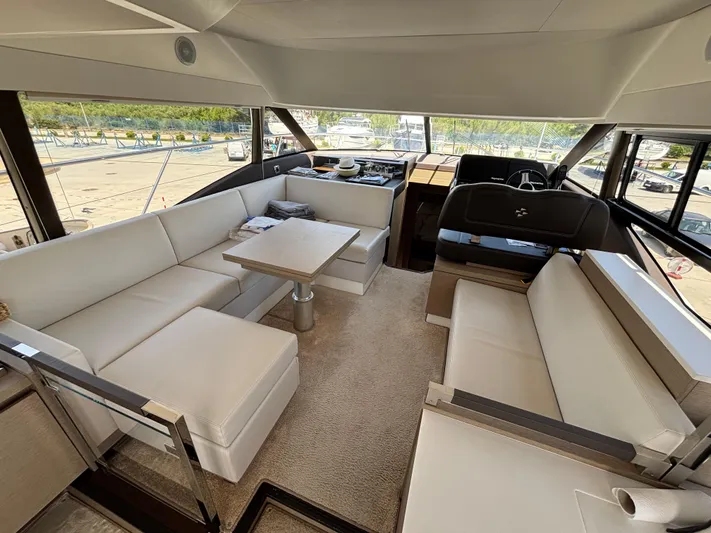  Yacht Photos Pics Luxurious interior of 2020 Jeanneau Prestige 460 yacht with elegant seating and panoramic windows.