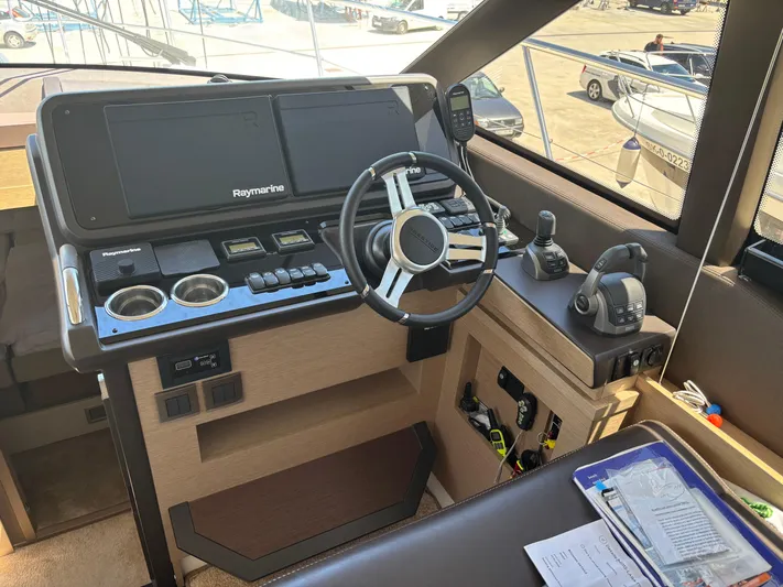  Yacht Photos Pics Helm of 2020 Jeanneau Prestige 460 yacht with modern navigation equipment.