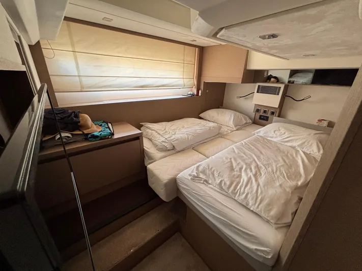  Yacht Photos Pics Cozy cabin interior of 2020 Jeanneau Prestige 460 yacht with twin beds and window blinds.