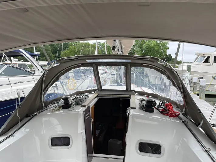  Yacht Photos Pics 2023 Jeanneau Sun Odyssey 349 sailboat cockpit with canopy, docked at marina.