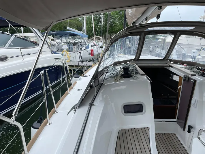  Yacht Photos Pics 2023 Jeanneau Sun Odyssey 349 sailboat cockpit with modern design and marina view.