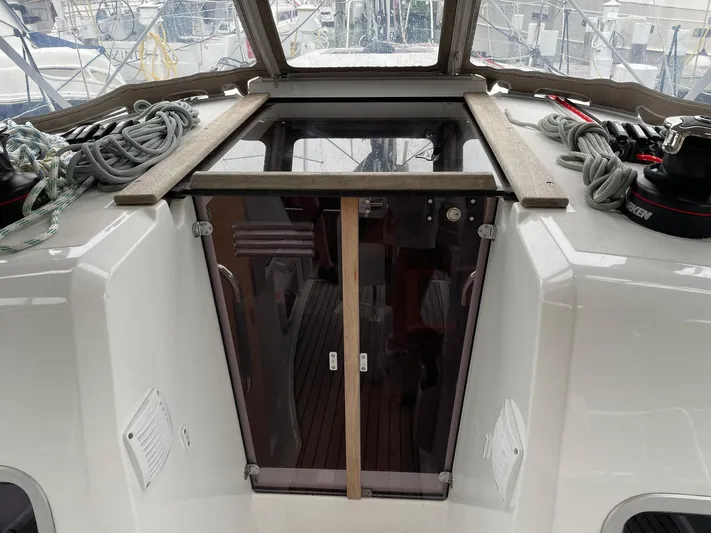  Yacht Photos Pics 2023 Jeanneau Sun Odyssey 349 yacht cockpit with ropes and hatch entrance.