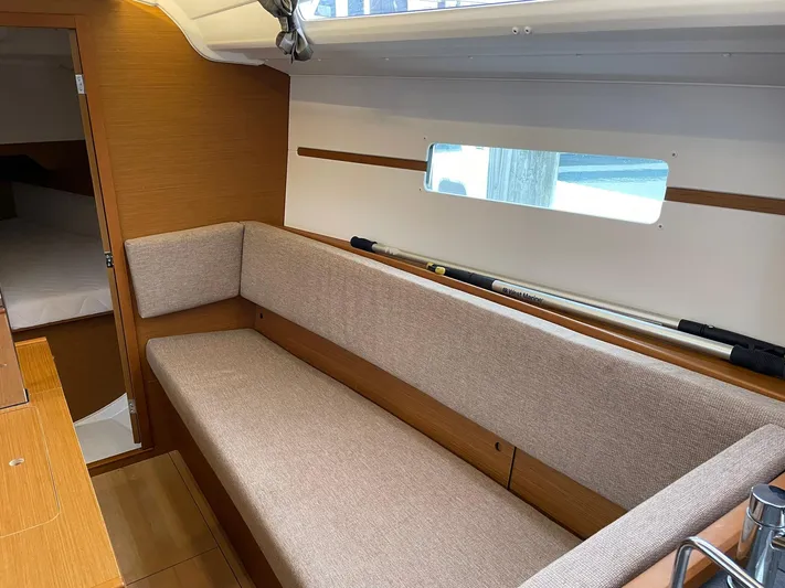  Yacht Photos Pics Interior of 2023 Jeanneau Sun Odyssey 349 sailboat, featuring a cozy seating area.