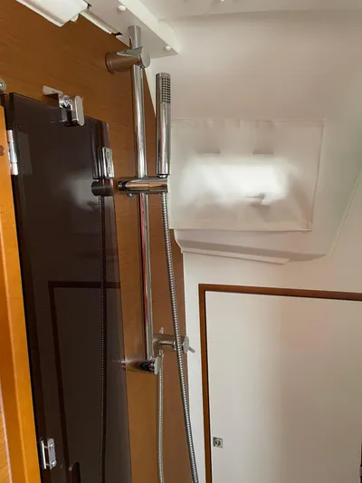  Yacht Photos Pics 2023 Jeanneau Sun Odyssey 349 interior shower with modern fixtures and wooden accents.