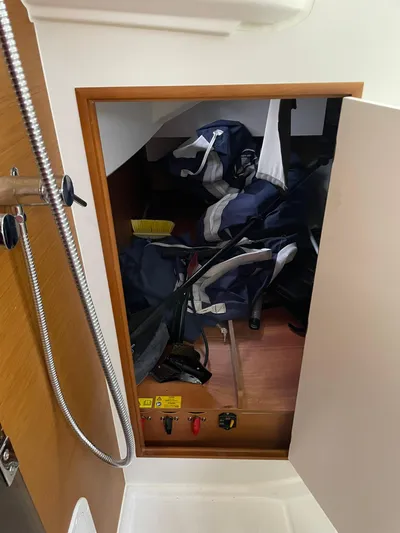  Yacht Photos Pics Storage compartment on 2023 Jeanneau Sun Odyssey 349 sailboat, featuring sailing gear and equipment.