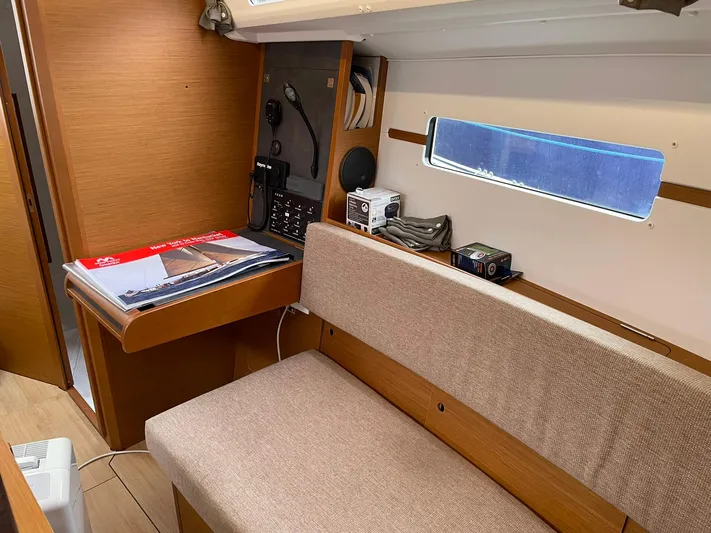  Yacht Photos Pics 2023 Jeanneau Sun Odyssey 349 interior with navigation station and seating area.