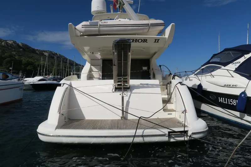  Yacht Photos Pics 2004 Azimut 55 yacht docked at marina, rear view with clear sky background.