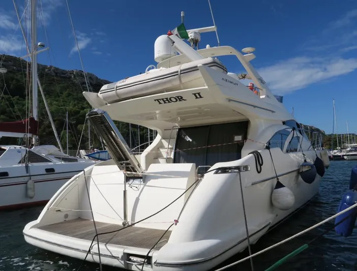  Yacht Photos Pics 2004 Azimut 55 yacht docked at marina, rear view with clear sky.