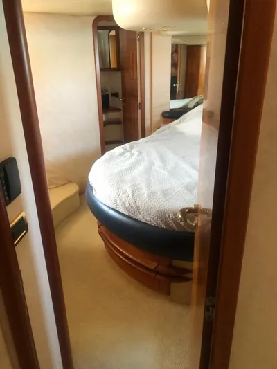  Yacht Photos Pics Luxurious bedroom interior of a 2004 Azimut 55 yacht with elegant wood finishes.