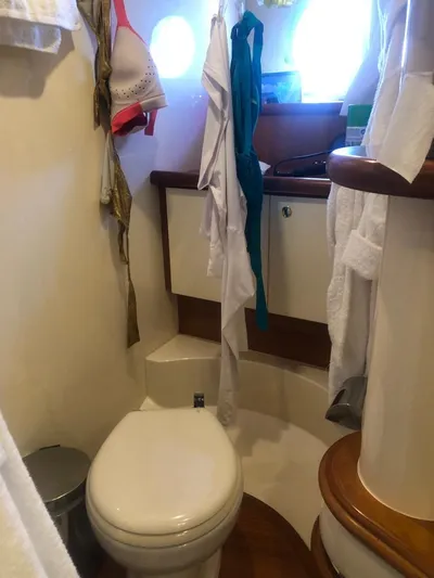  Yacht Photos Pics Bathroom interior of a 2004 Azimut 55 yacht with clothing and accessories.