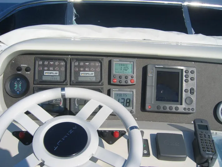  Yacht Photos Pics Control panel of a 2004 Azimut 55 yacht with navigation instruments and steering wheel.