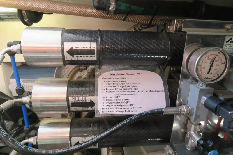  Yacht Photos Pics Engine compartment of a 2004 Azimut 55 yacht, featuring filtration system and pressure gauge.