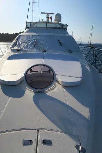  Yacht Photos Pics 2004 Azimut 55 yacht deck with sunbathing area and hatch, cruising on calm waters.