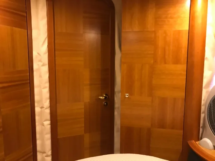  Yacht Photos Pics Interior of a 2004 Azimut 55 yacht with wooden doors and warm lighting.