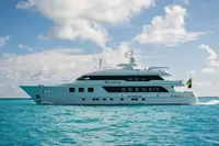 Luxurious 2006 Burger Trideck yacht cruising on clear blue ocean waters.