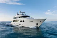 Luxurious 2006 Burger Trideck yacht cruising on calm ocean waters.
