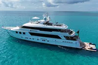 Luxurious 2006 Burger Trideck yacht on turquoise ocean waters.