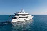 Luxury 2006 Burger Trideck yacht cruising on open sea under clear blue sky.