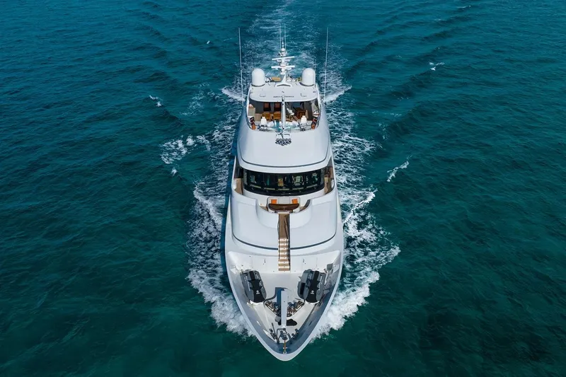 Crossed Sabre Yacht Photos Pics Luxury yacht Burger Trideck 2006 cruising on clear blue ocean waters.