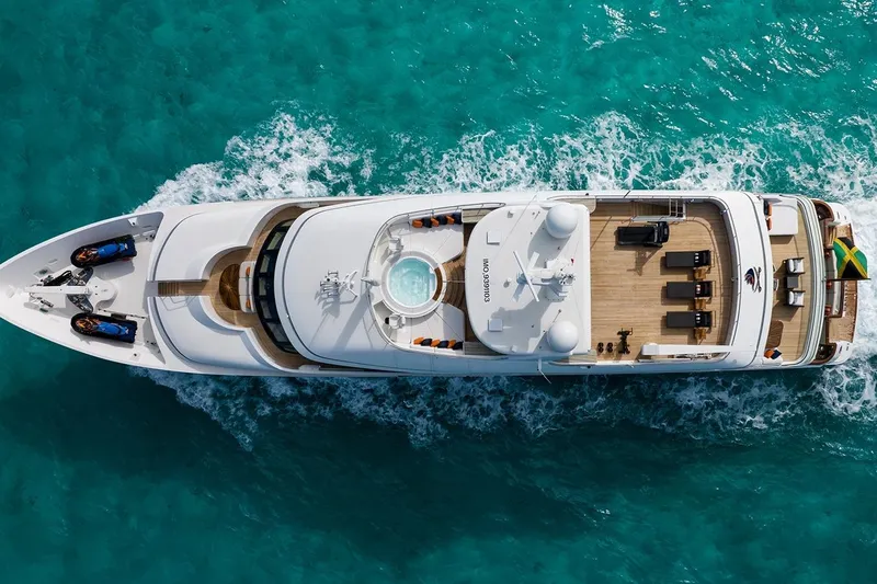 Crossed Sabre Yacht Photos Pics Aerial view of 2006 Burger Trideck yacht cruising in turquoise waters.