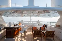Luxurious 2006 Burger Trideck yacht deck with bar, seating, and ocean view.