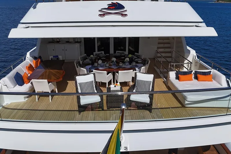 Crossed Sabre Yacht Photos Pics Luxurious 2006 Burger Trideck yacht deck with elegant seating and dining area.