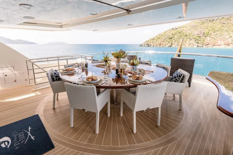 Crossed Sabre Yacht Photos Pics Luxurious dining setup on 2006 Burger Trideck yacht with ocean view.