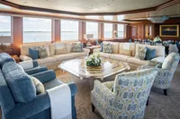 Luxurious yacht interior with elegant seating, large windows, and ocean view on a 2006 Burger Trideck.