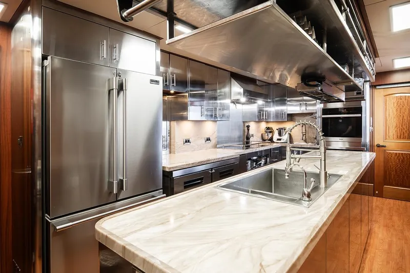 Crossed Sabre Yacht Photos Pics Luxurious kitchen interior on 2006 Burger Trideck yacht with stainless steel appliances.