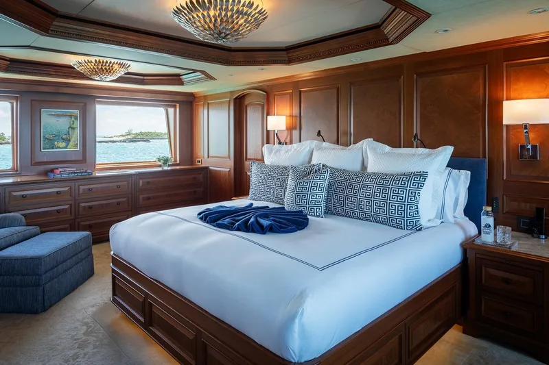 Crossed Sabre Yacht Photos Pics Luxurious bedroom on 2006 Burger Trideck yacht with elegant wood paneling and ocean view.