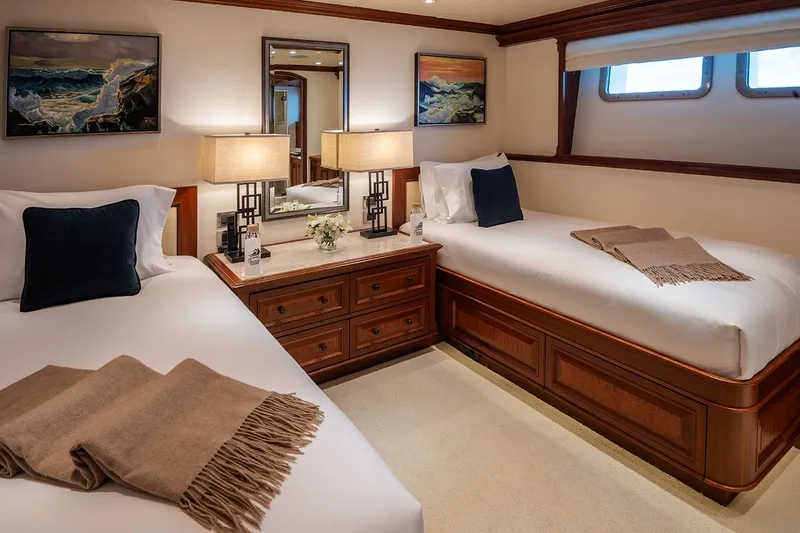Crossed Sabre Yacht Photos Pics Luxurious twin bedroom on 2006 Burger Trideck yacht with elegant decor and ocean-themed artwork.