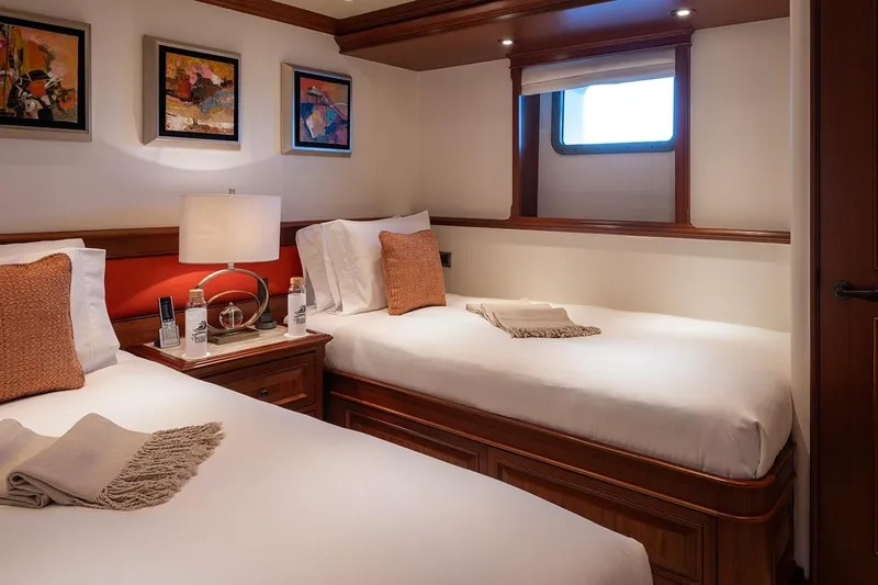 Crossed Sabre Yacht Photos Pics Luxurious twin cabin on 2006 Burger Trideck yacht with elegant decor and cozy bedding.