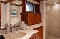 Luxurious bathroom on 2006 Burger Trideck yacht with marble shower and wooden cabinetry.