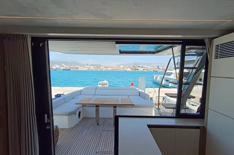  Yacht Photos Pics Interior view of 2020 Prestige 590 yacht overlooking marina and blue sea.