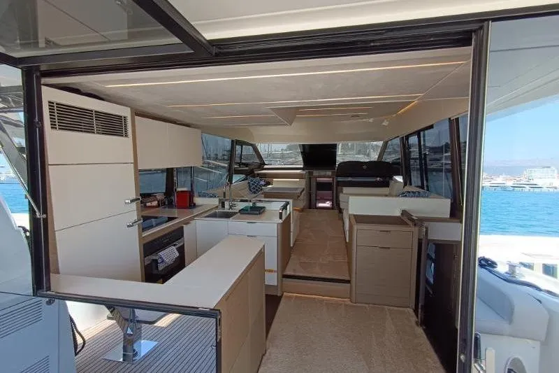  Yacht Photos Pics Luxurious interior of a 2020 Prestige 590 yacht with modern kitchen and seating area.