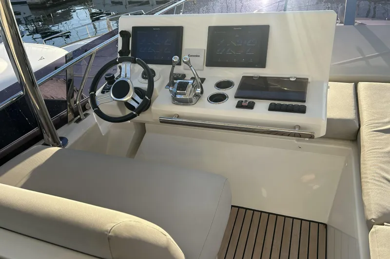  Yacht Photos Pics Cockpit of 2020 Prestige 590 yacht with modern steering and control panels.